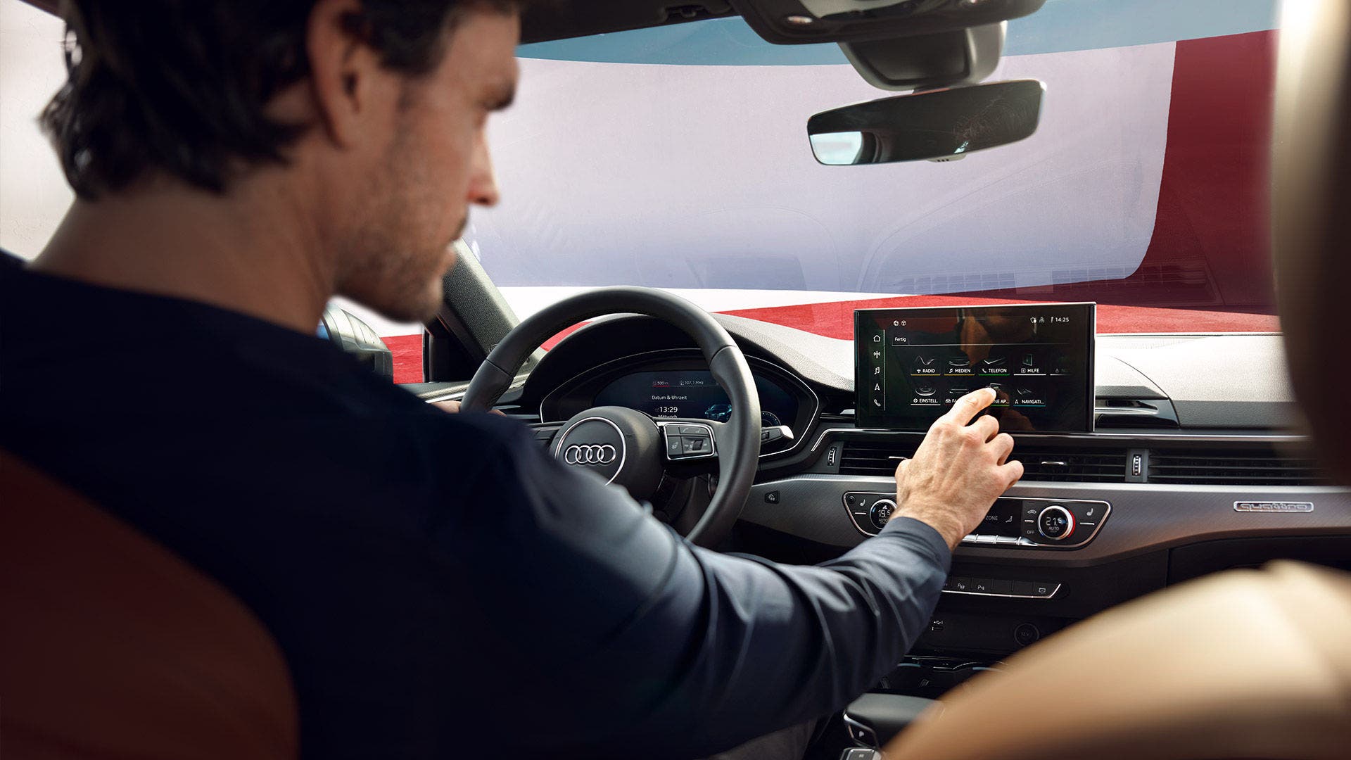Image of a man using the MMI touch display in his Audi.