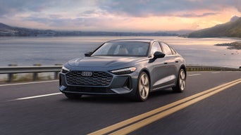 Three-quarter front view of the Audi Q4 e-tron making a turn. 