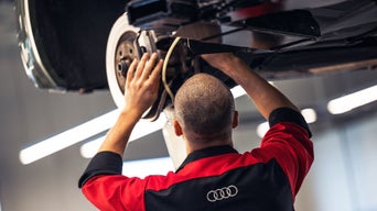 Service technician repairing vehicle tires.