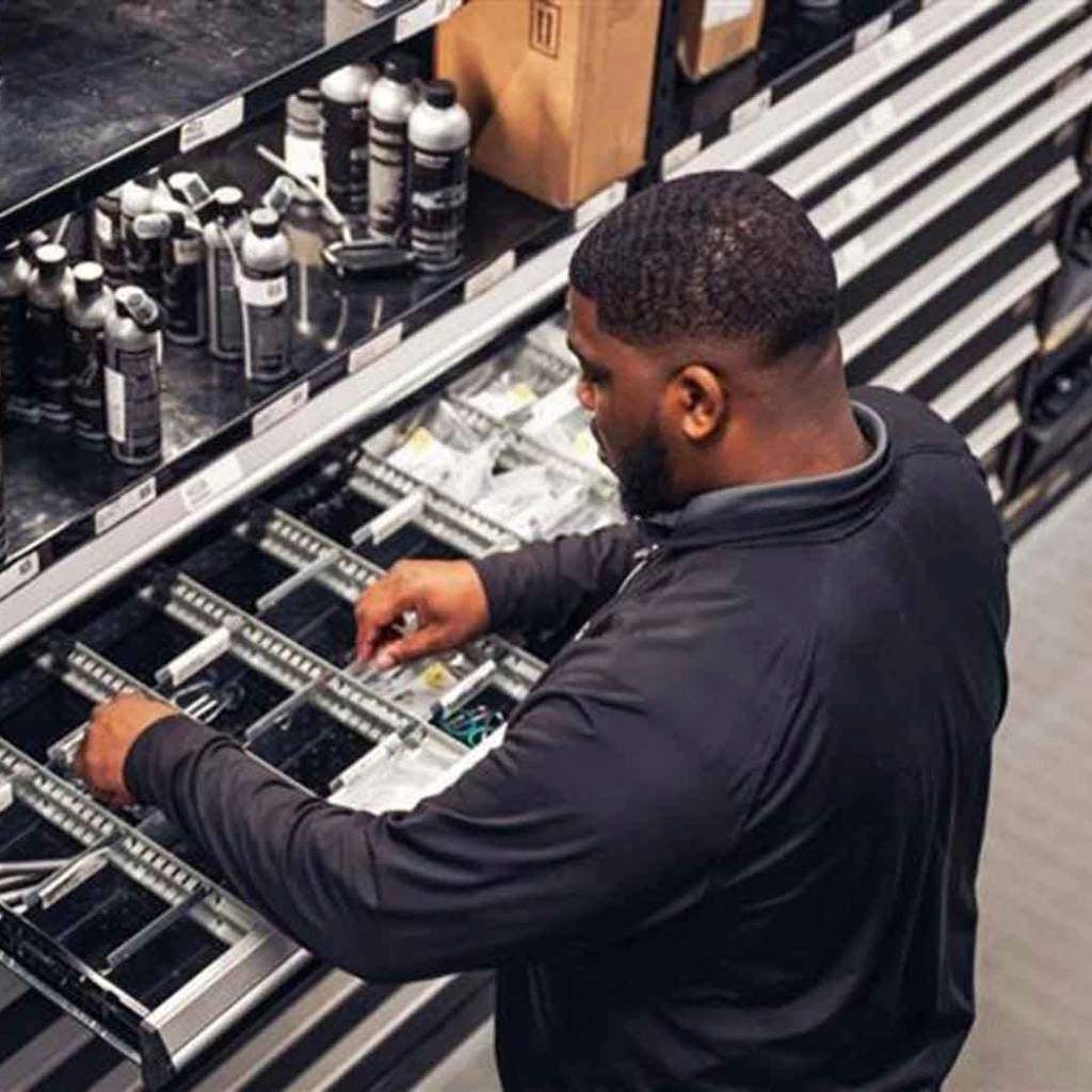 Audi service technician servicing a vehicle.