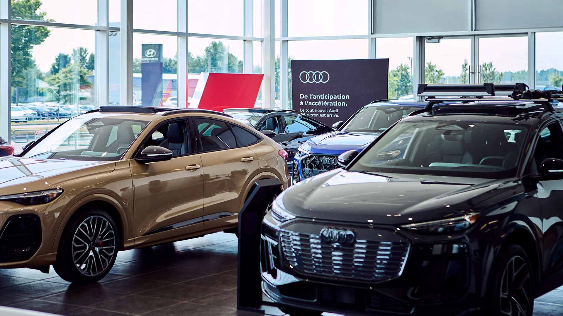 Audi vehicles in the dealership showroom.