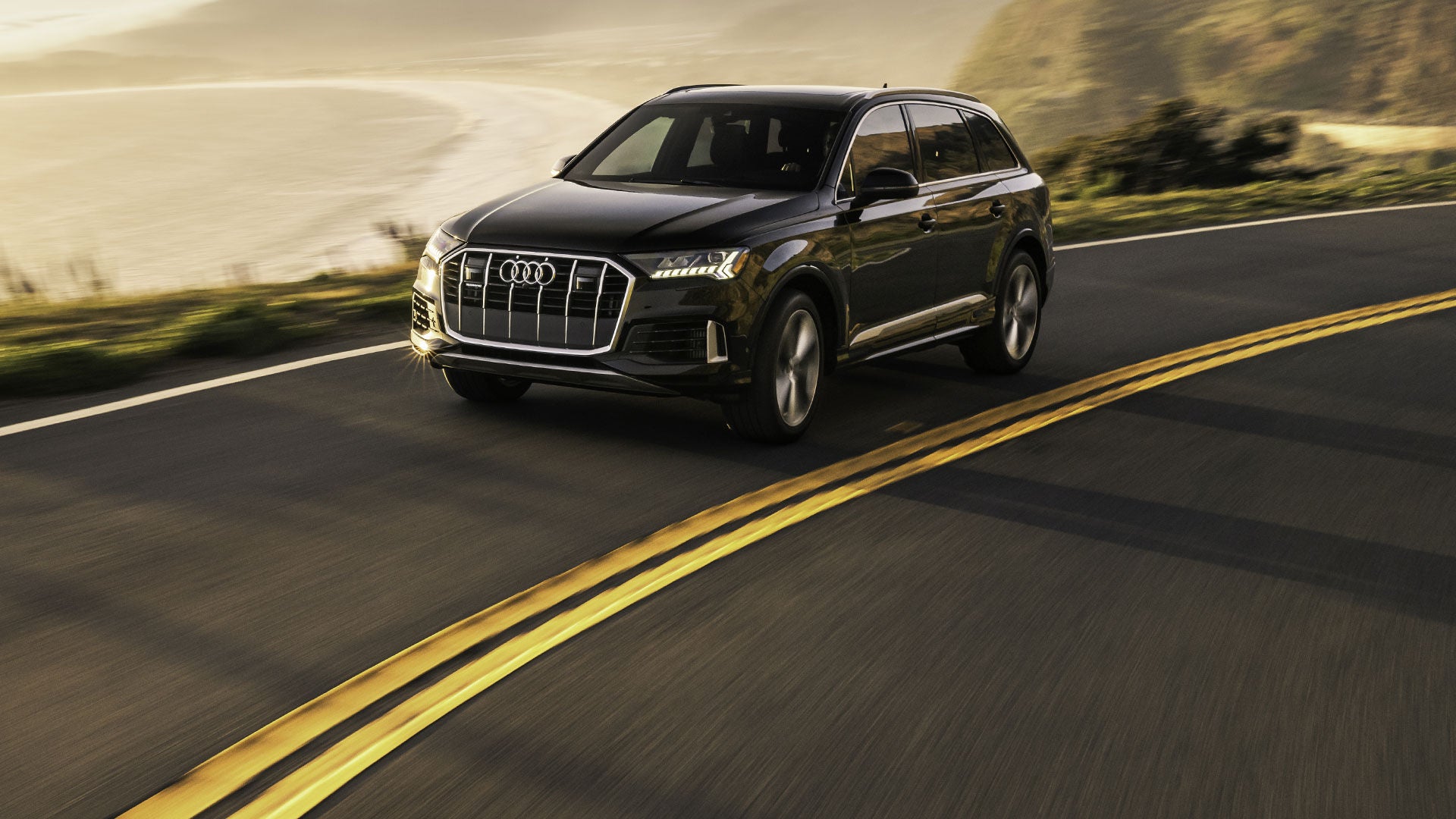 Three-quarter front view of the Audi Q7 accelerating.