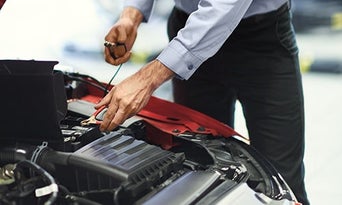 Man inspecting vehicle. 