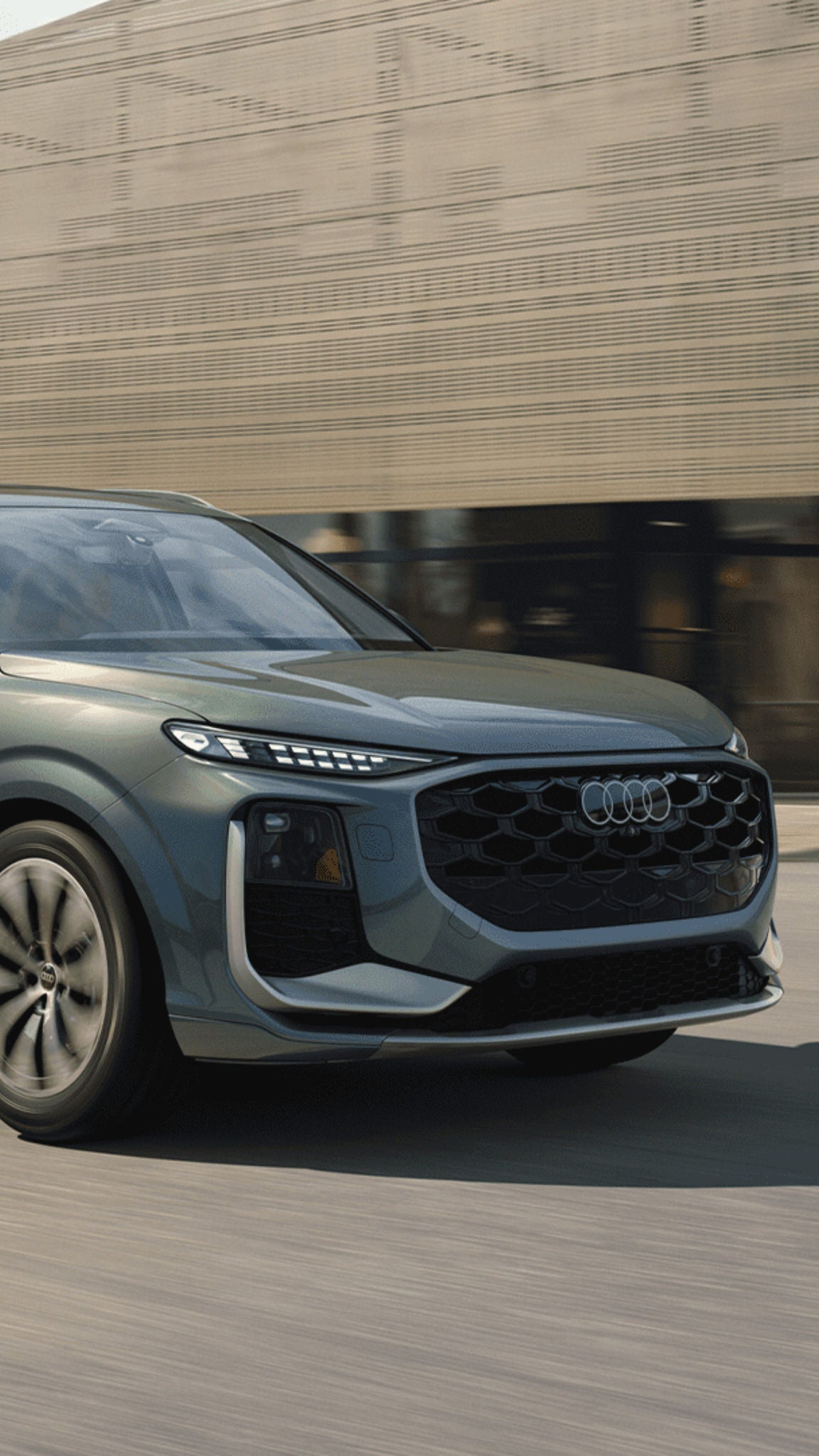 Left side profile view of an Audi vehicle accelerating.