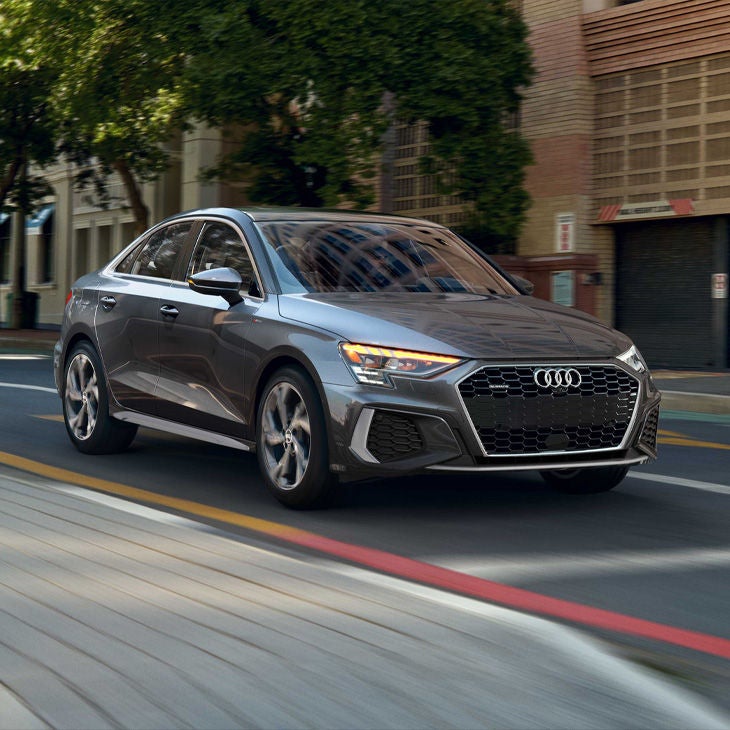 Three-quarter front view of a grey Audi A3 equipped with Adaptive cruise assist technology.