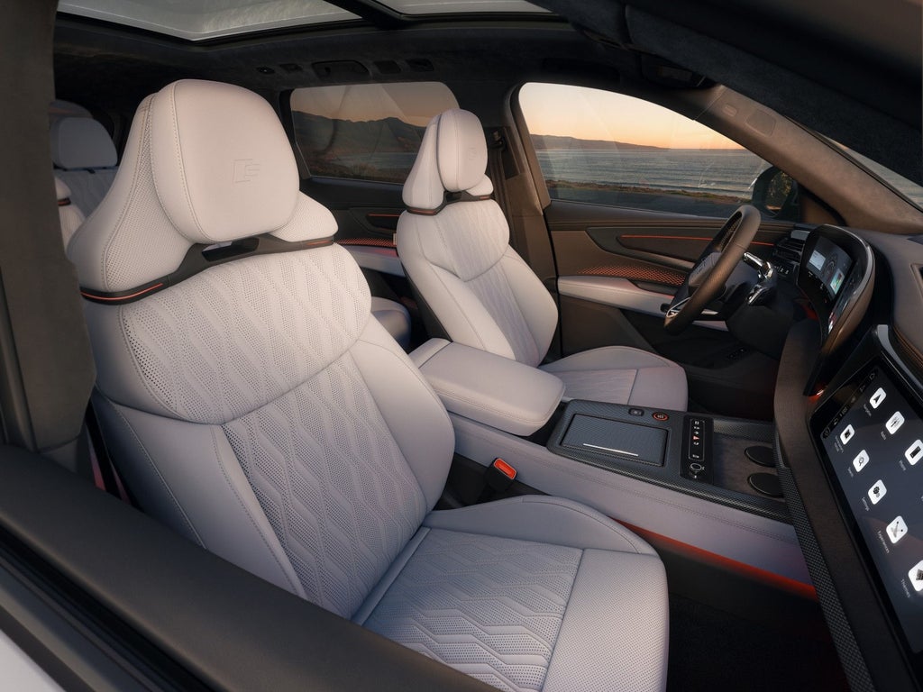 A view of the interior from the passenger side, focusing on the first two rows of seats.