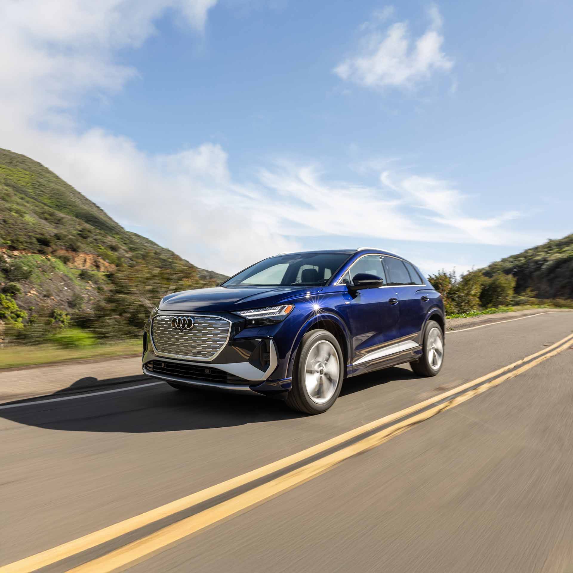 Left profile view of an Audi driving.