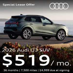 An Audi Q3 parked near water.