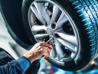 Service technician servicing vehicle.