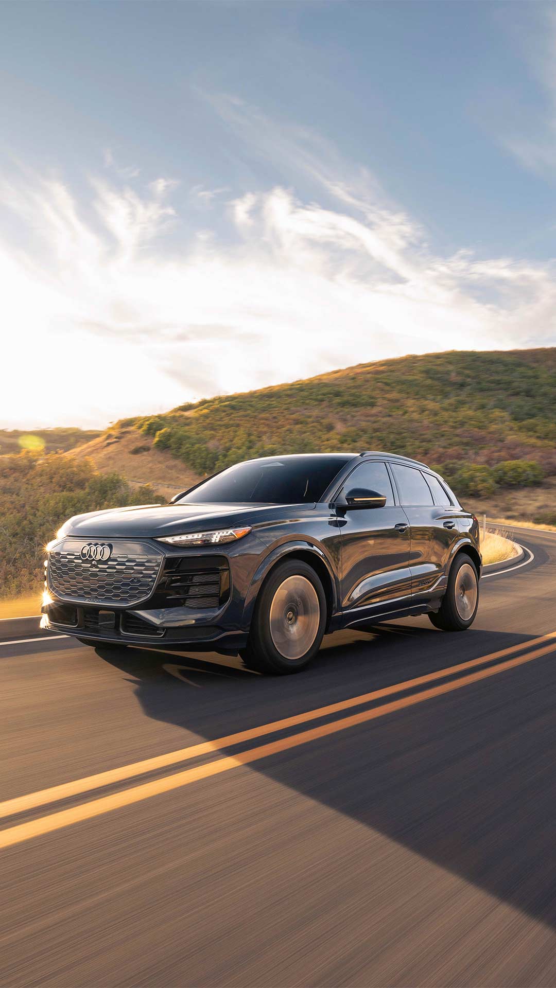 Audi State College building with 2 Audi vehicles parked outside