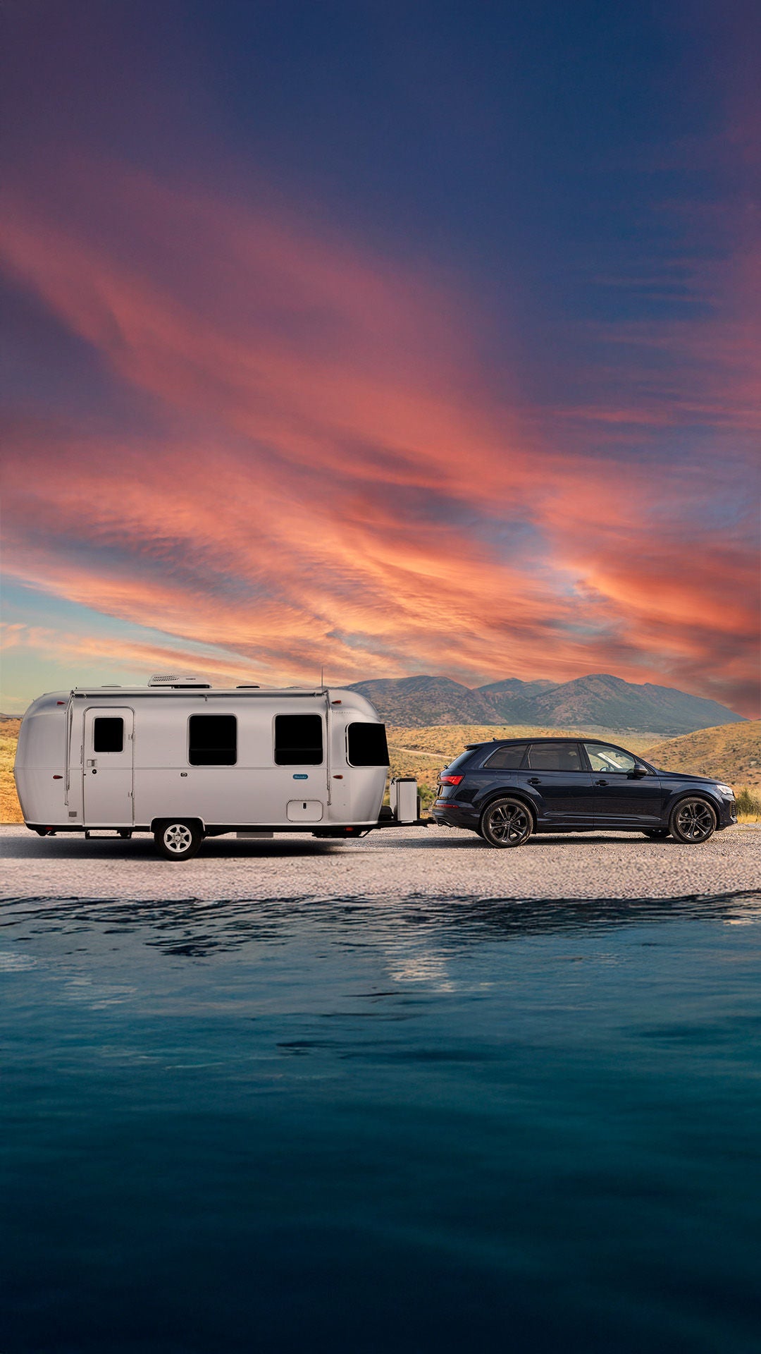 2026 Audi Q7 towing an Airstream Bambi at sunset