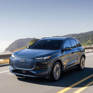 Side view of an Audi Q6 driving.