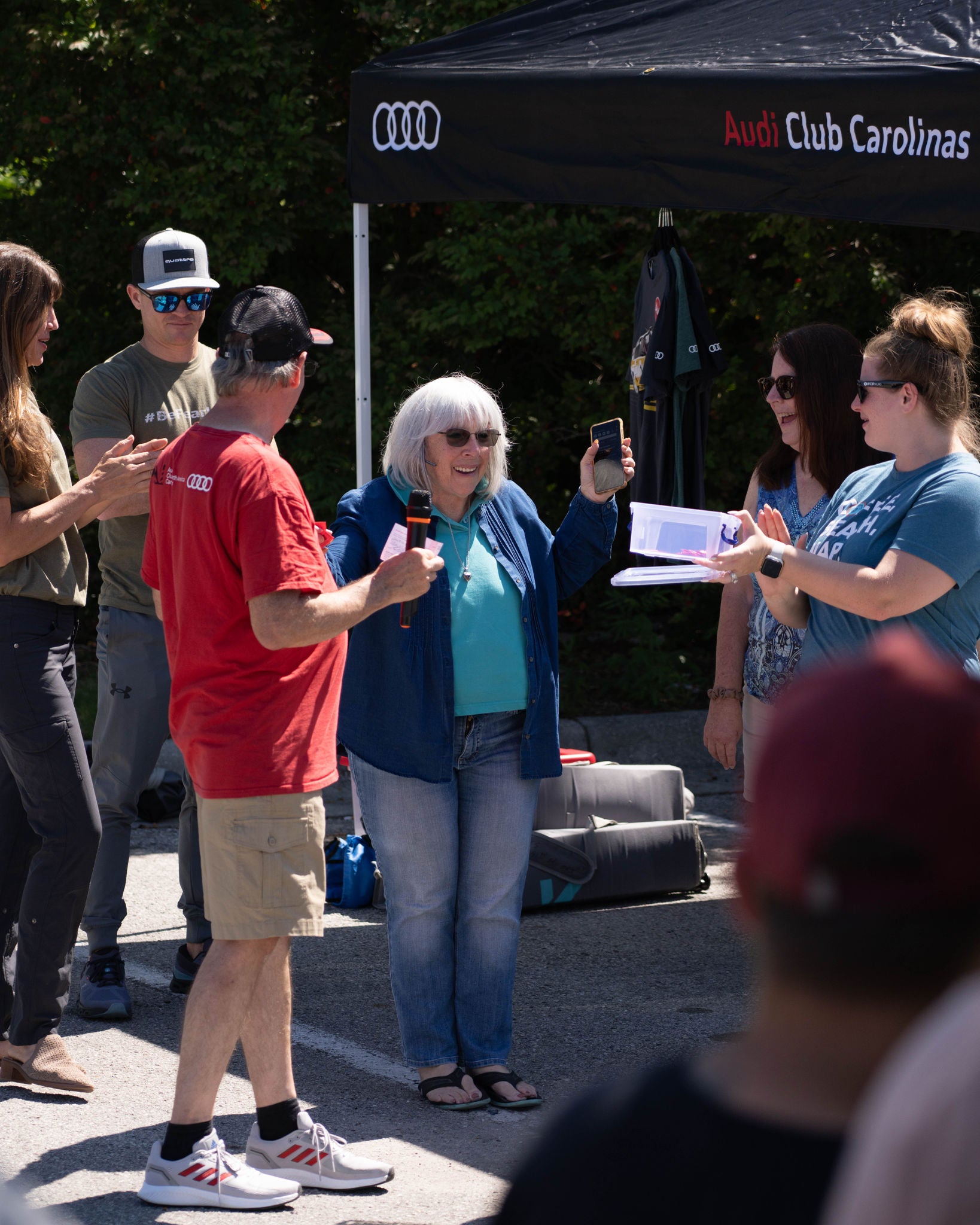 A group of men holding t-shirt from a community run