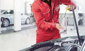 Service technician changing oil.