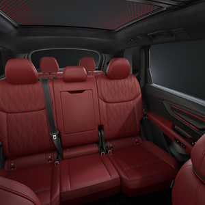 View of the rear seats of the Audi SQ7 SUV with red leather and diamond stitching.