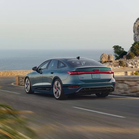 Rear 3/4 view of the Audi S6 Sportback e-tron charging.