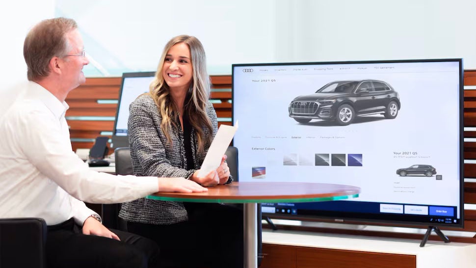 Customer working with a Sales Associate to order a new Audi SUV.