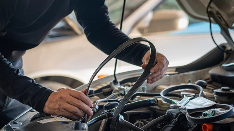 Audi service technician servicing a vehicle.