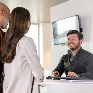 Couple consulting with an Audi advisor — view pre-owned inventory at Audi Sewickley near Pittsburgh PA