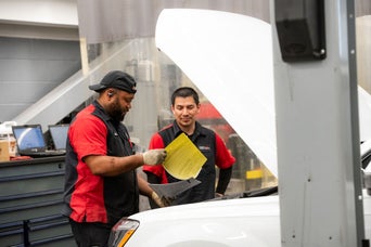 Technicians consulting Audi Multipoint Inspection