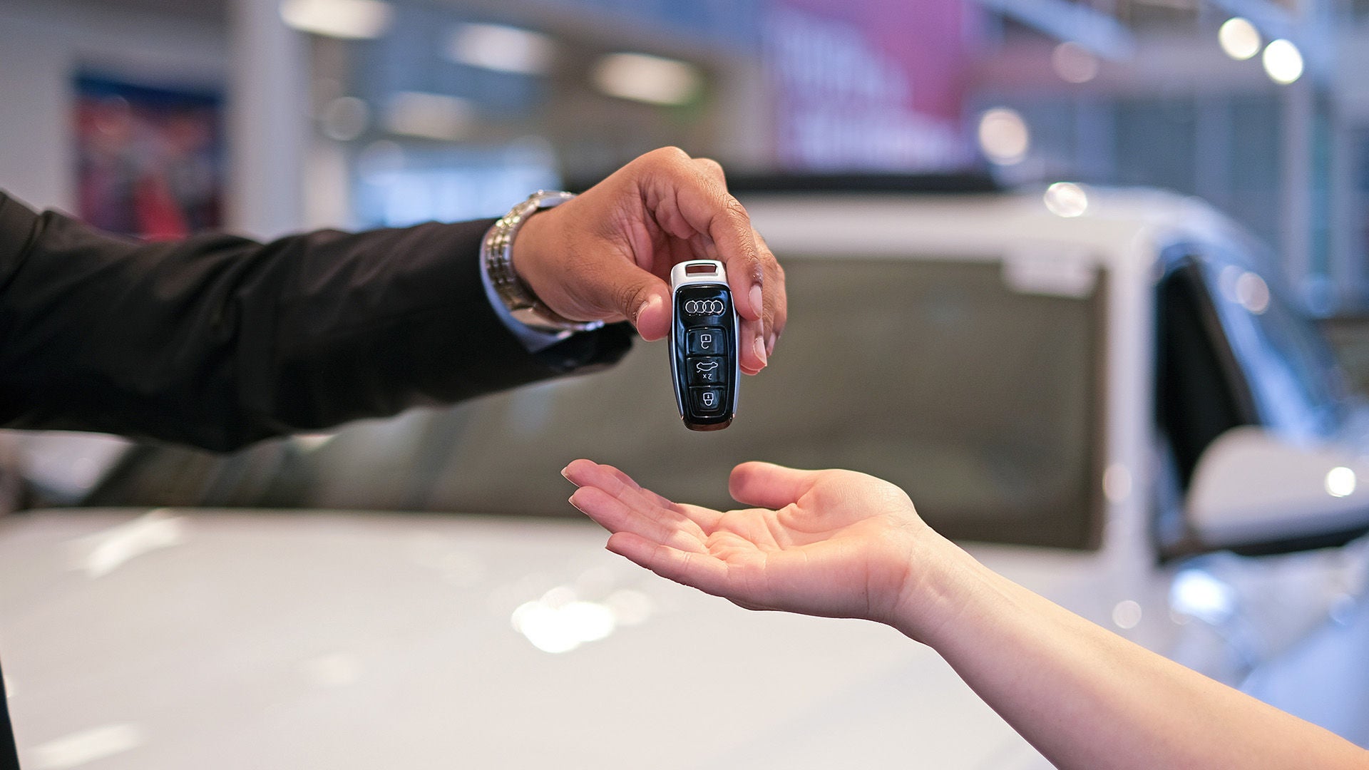 Audi finance specialist handing over keys to a customer