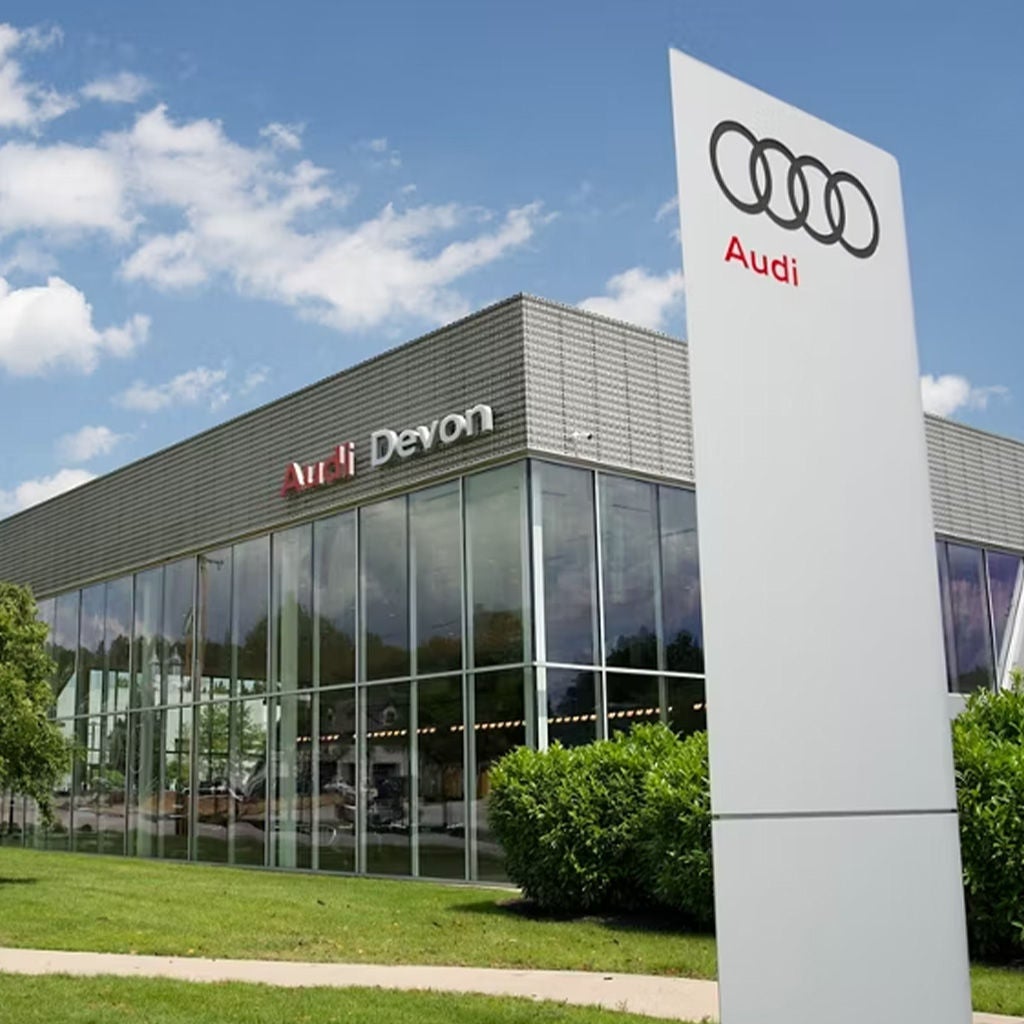 Two people chatting with each other across the charging station.