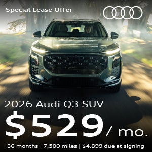 An Audi Q3 driving through the forest.