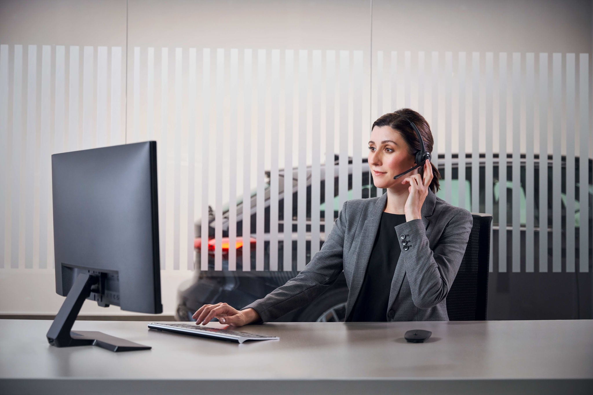 Woman sitting at desk Audi service