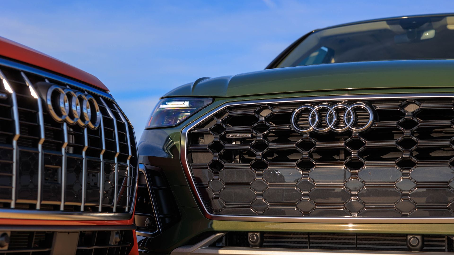 Close up of the front grilles of two Audi cars