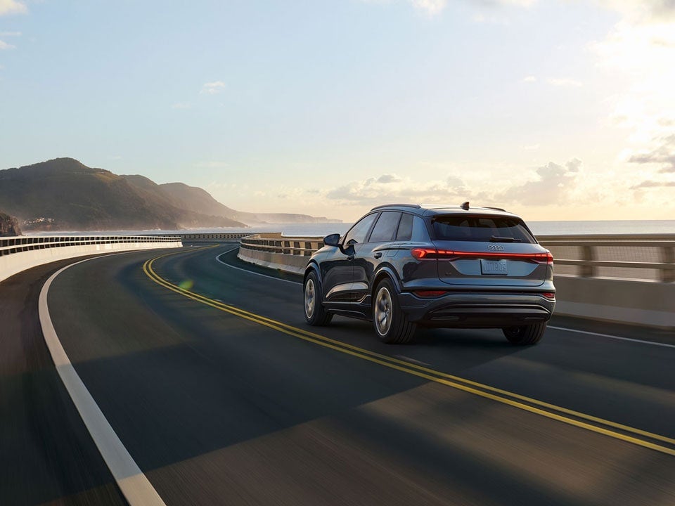 Audi Q6 driving on a coastal road