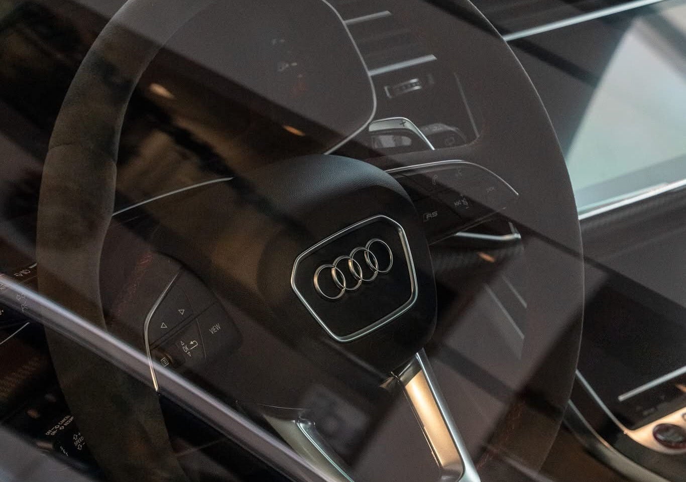 Audi employee handing a set of car keys to a customer.