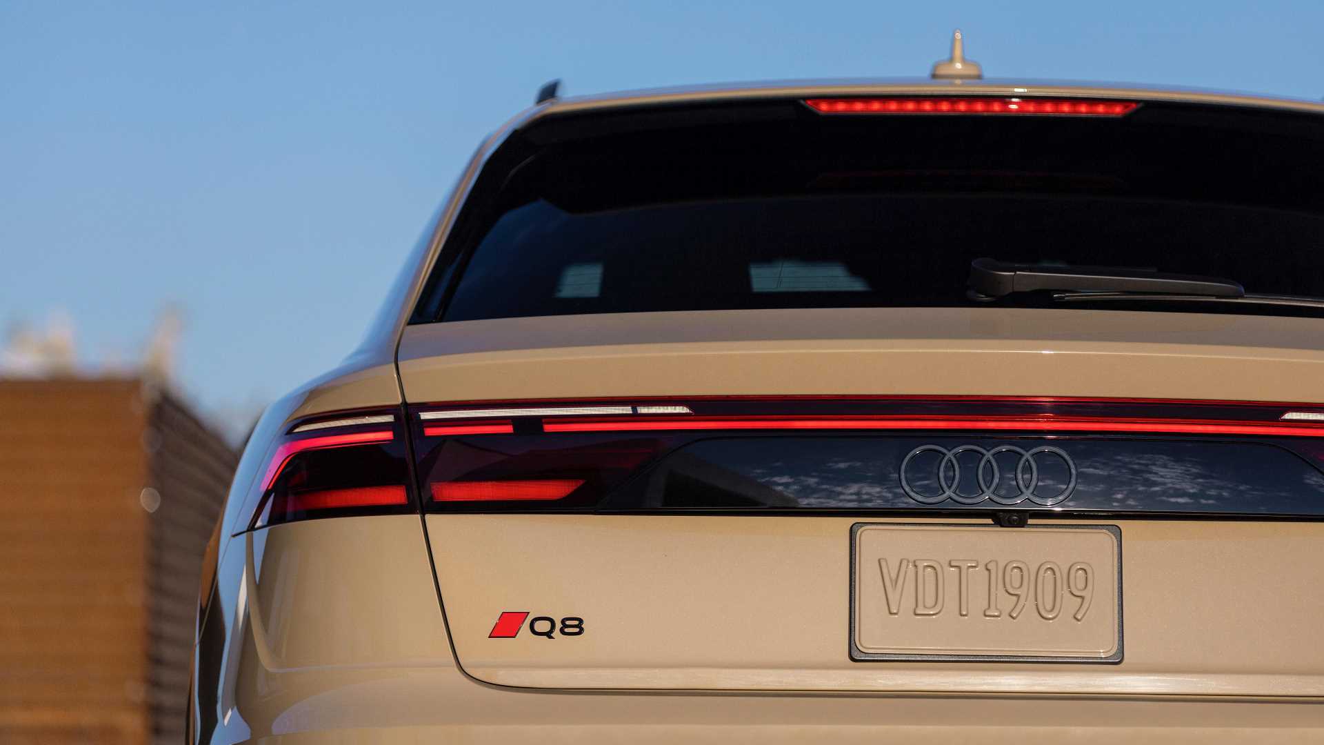 Rear profile view of an Audi Q8 SUV parked.