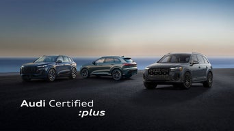 A row of Audi vehicles parked.