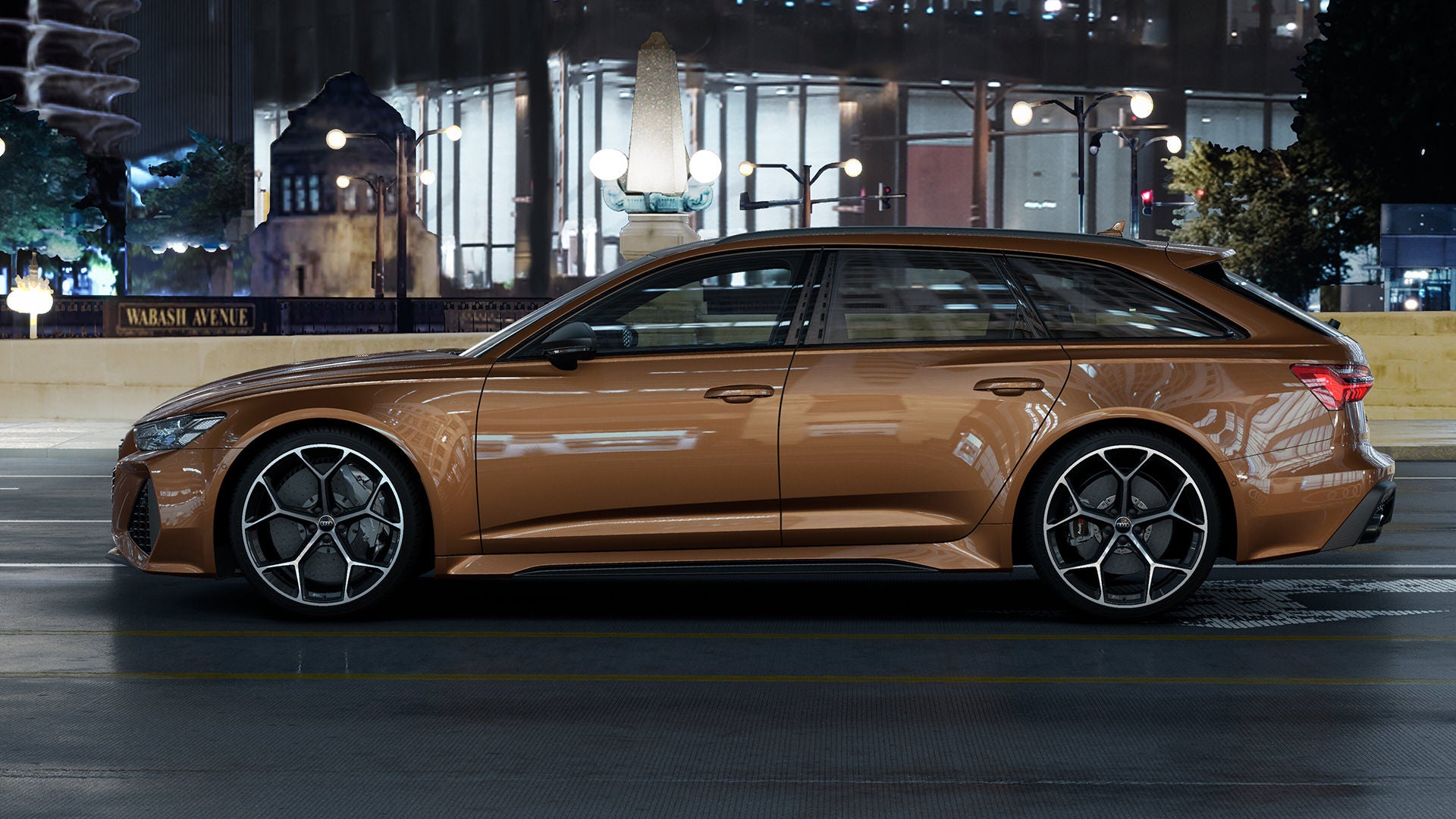 Side profile of a brown Audi RS 6 in motion on a city street. 