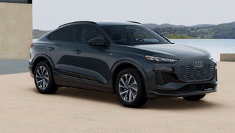 Audi Q6 e-tron parked in front of wall outdoors