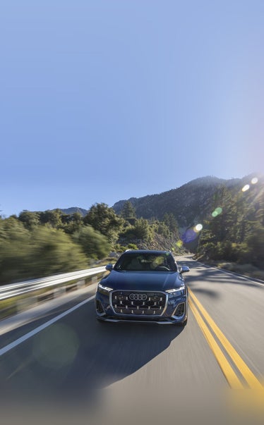 2026 Audi SQ7 in Ascari Blue driving up a canyon road near Pittsburgh PA