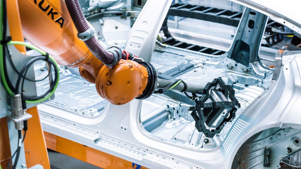A robotic arm checks 400 points on the frame of an Audi e-tron GT for dimensial accuracy.