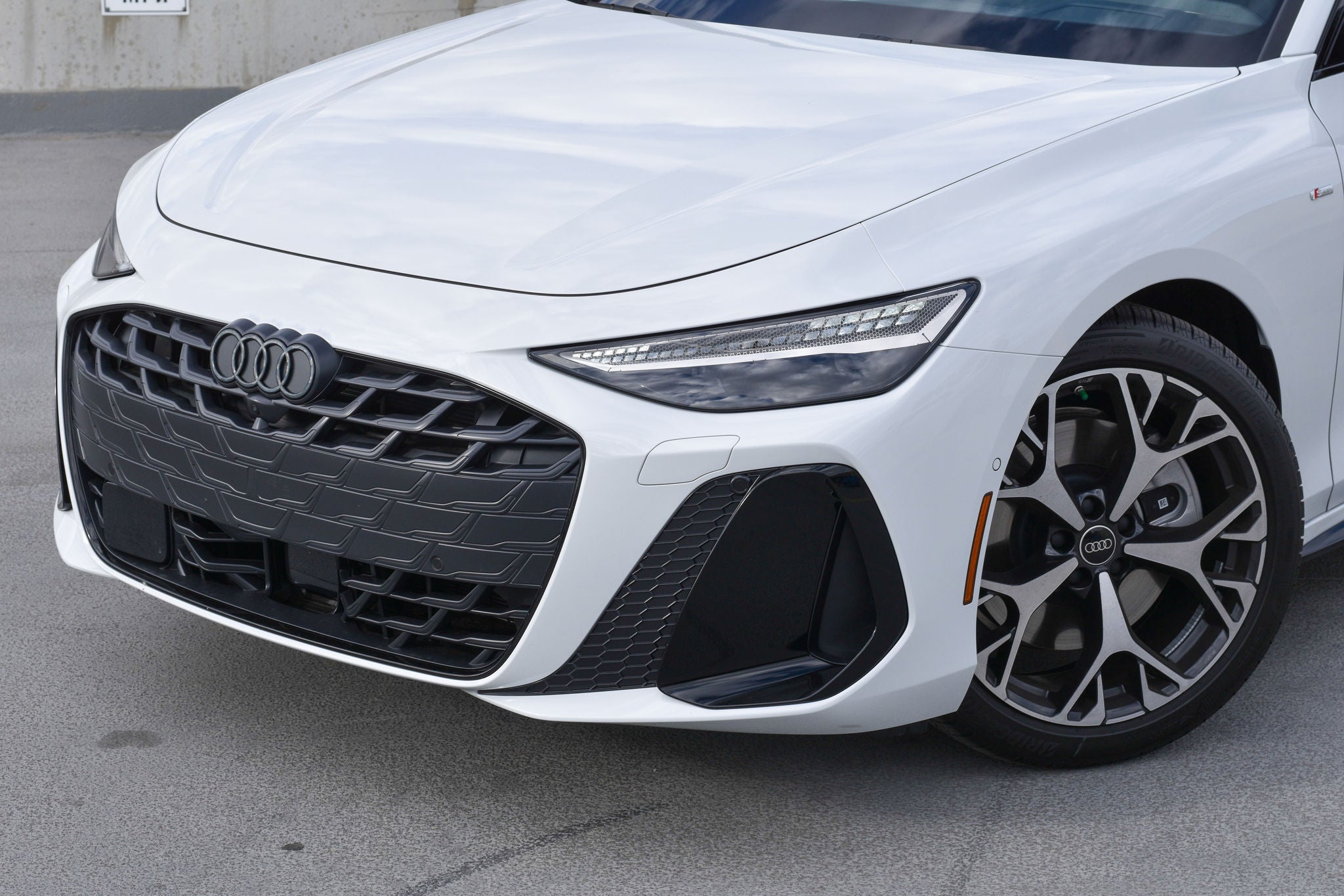 Front view of the 2025 Audi A5, Q5, and Q7 driving.