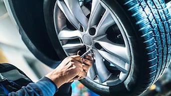 Service technician serving vehicle. 