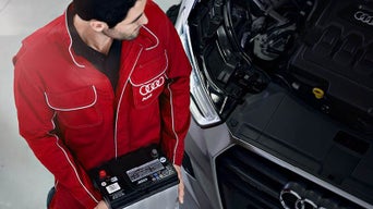 Service technician serving vehicle.