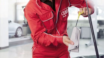 Service tech checking oil