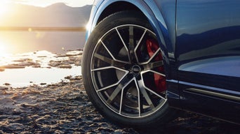 Close up of an Audi's front wheel in the sunset