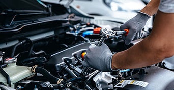 Service technician servicing vehicle. 