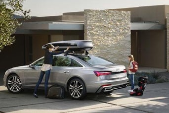 Family with Audi vehicle. 