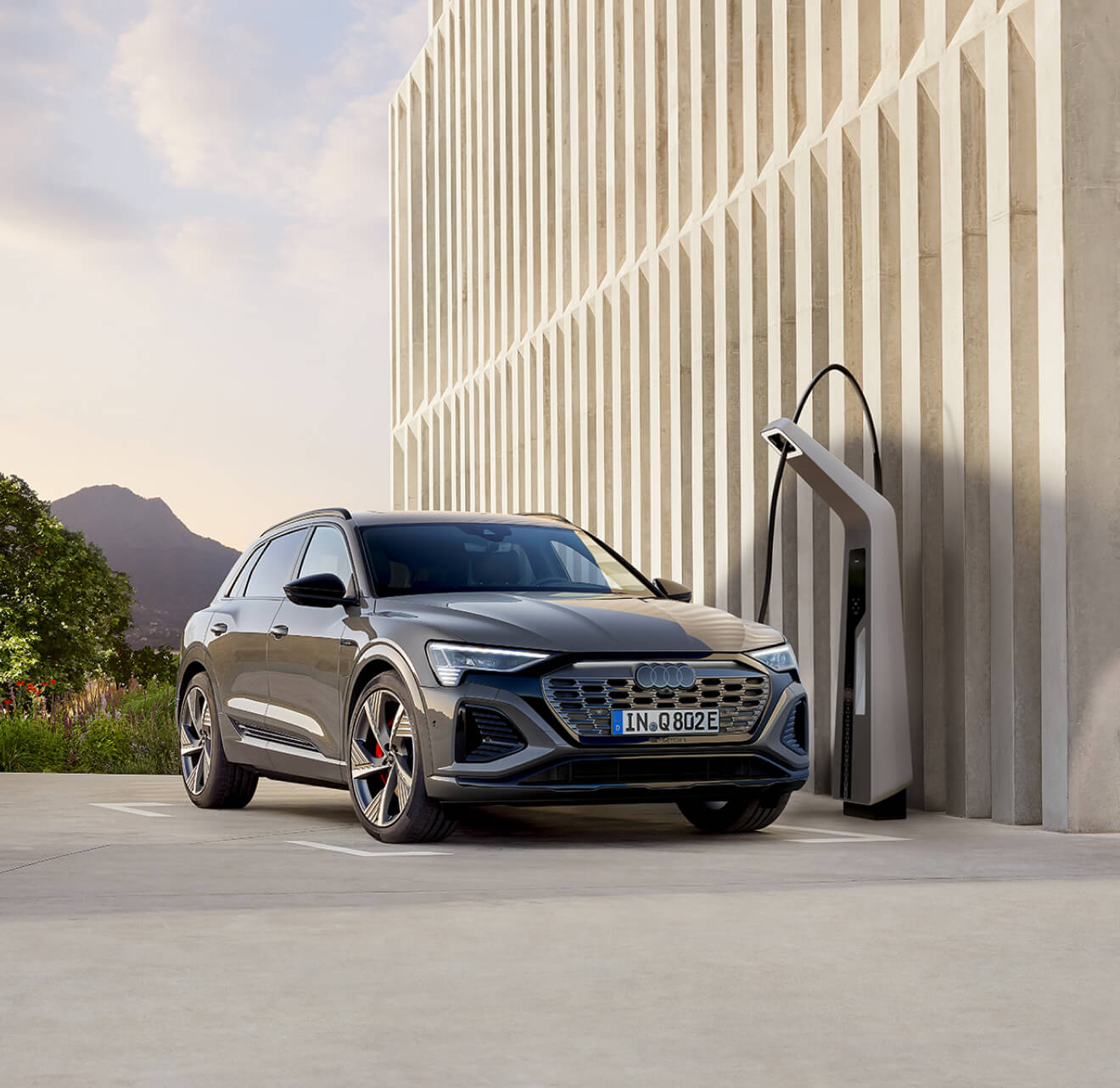 Audi SUV charging at a charging station