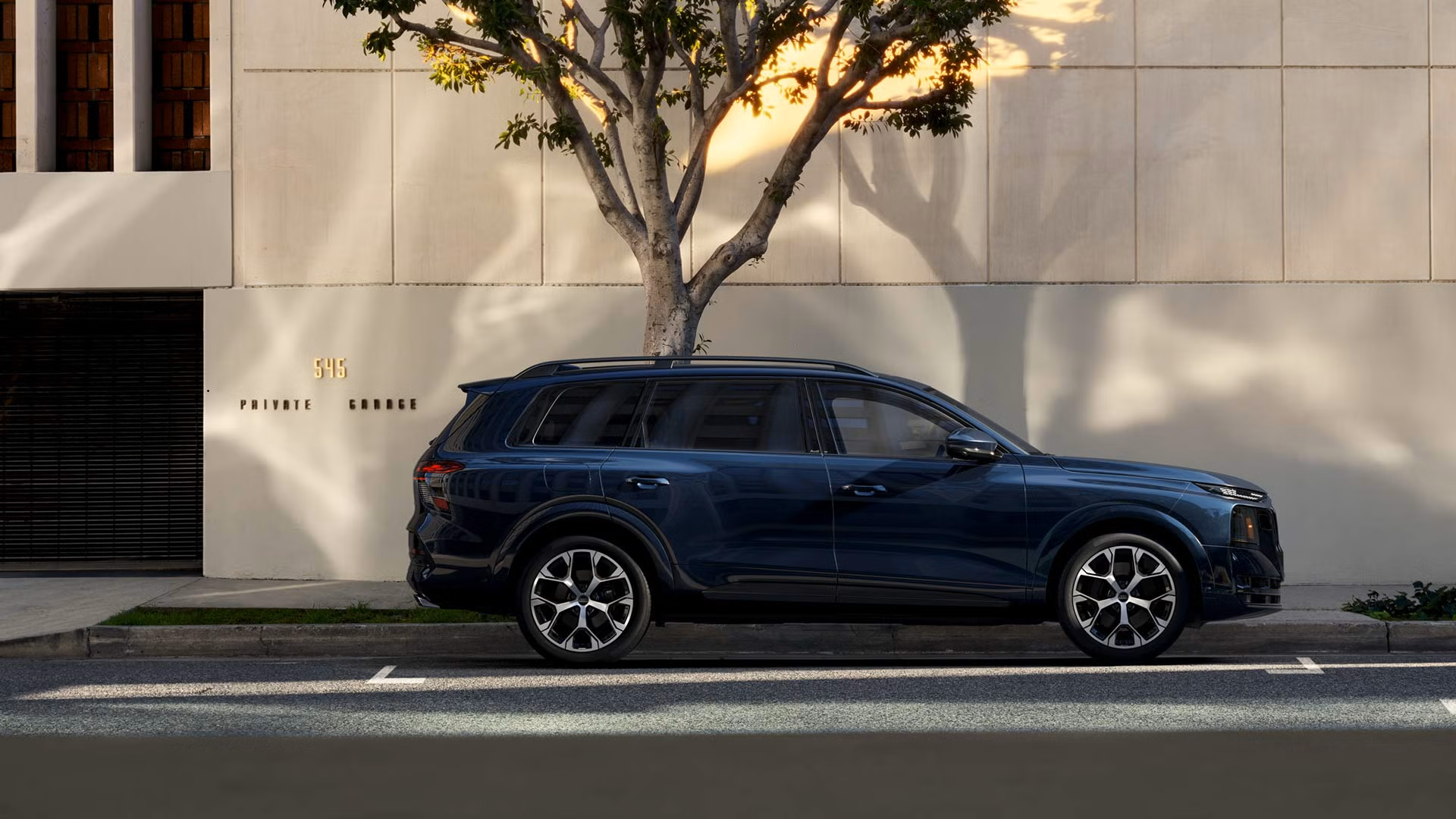Side-profile view of the Audi Q9 parked.