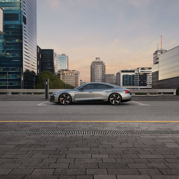 Side profile of the Audi S e-tron GT parked and charging.