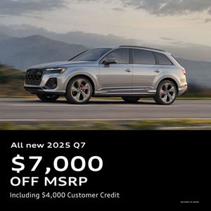 Side view of an Audi Q7 parked.