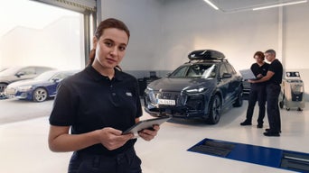 Audi Service technician servicing a vehicle.