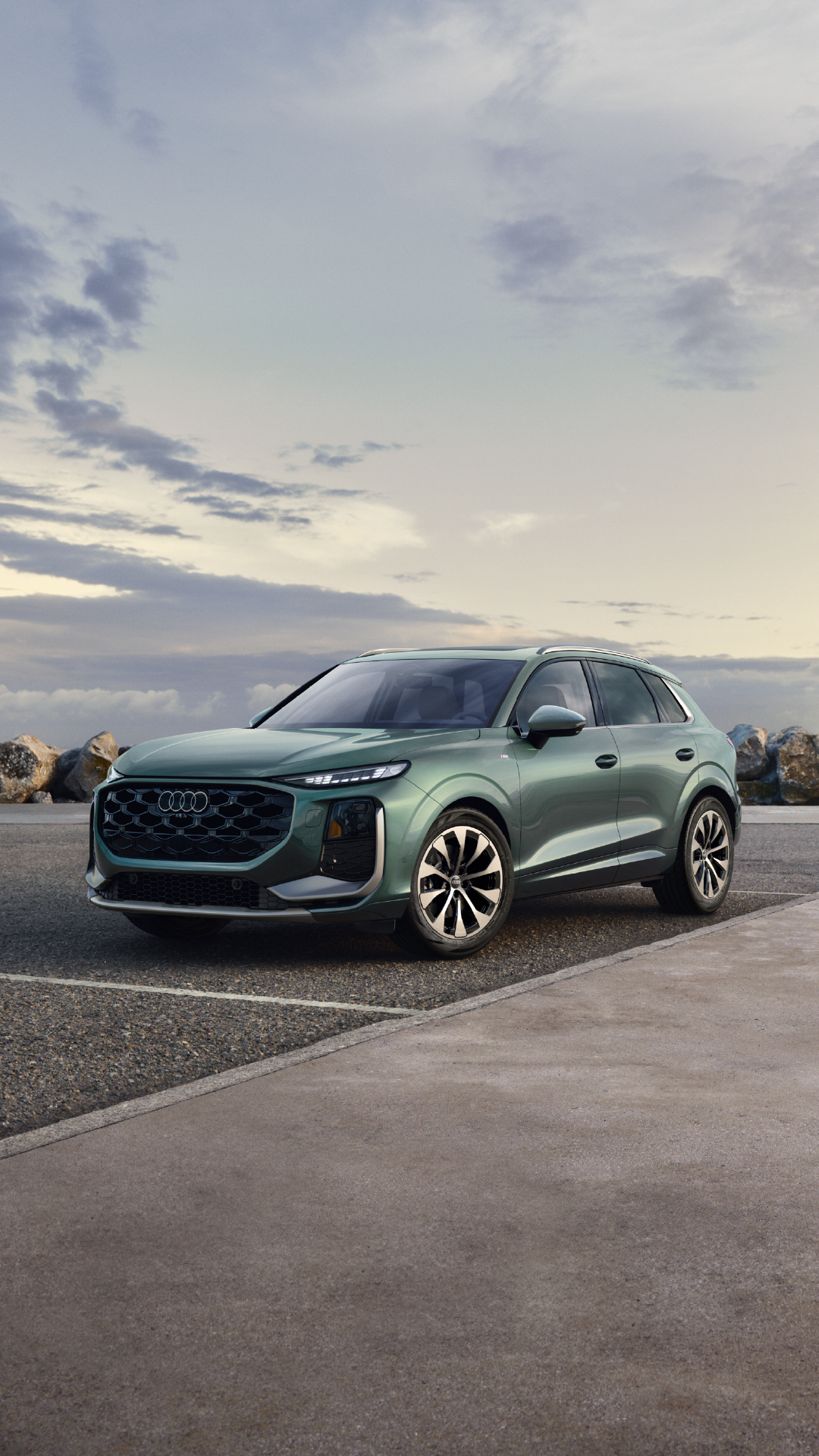 A blue 2026 Audi Q3 parked on a skyline